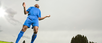 soccer player headbutting soccer ball