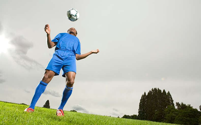 soccer player headbutting soccer ball