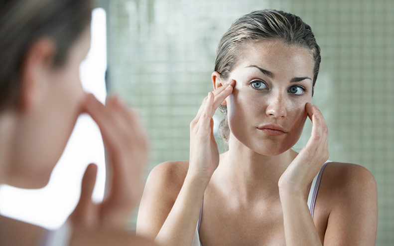 woman looking in mirror