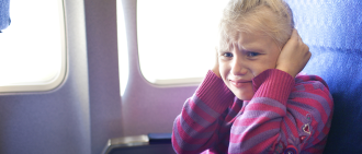 holding ears on airplane