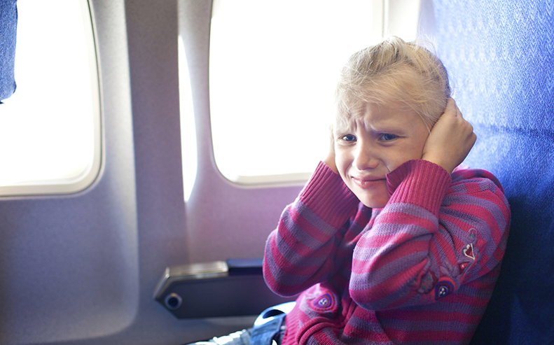 holding ears on airplane