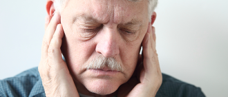 man holding ears