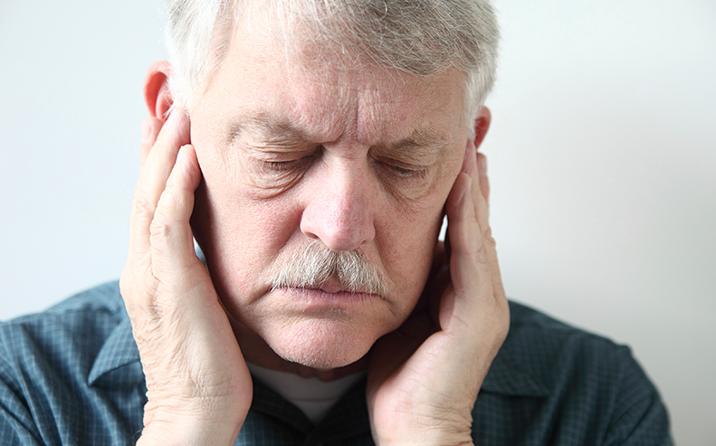 man holding ears