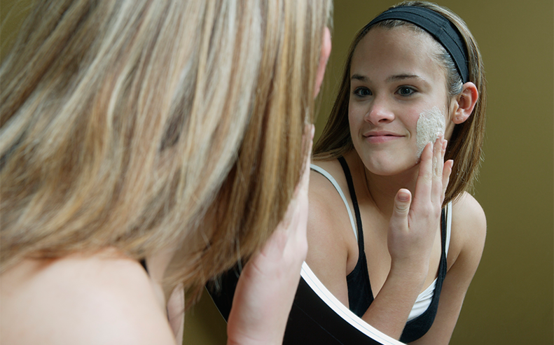 teen applying facial cream