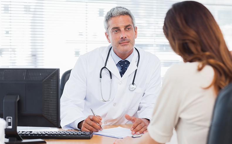 doctor talking to female patient