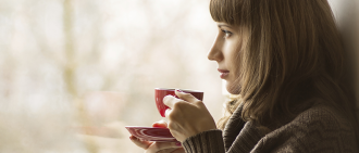 woman drinking hot beverage