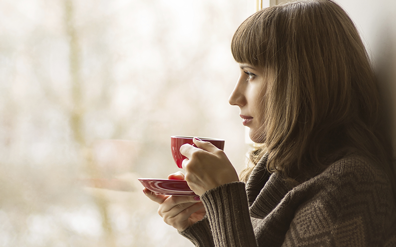 woman drinking hot beverage