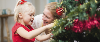 girl and mother by Christmas tree