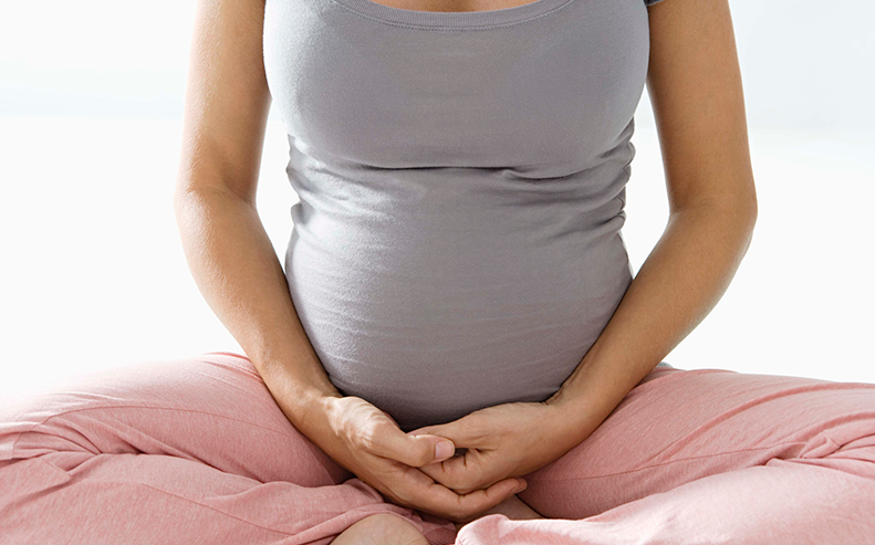 pregnant woman with legs crossed