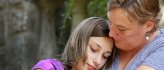 woman hugging daughter