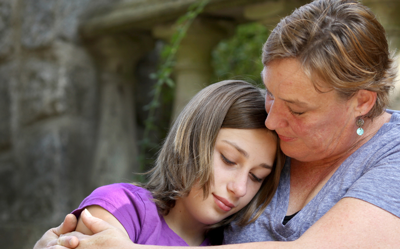 woman hugging daughter