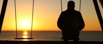 Lonely man looking out a water