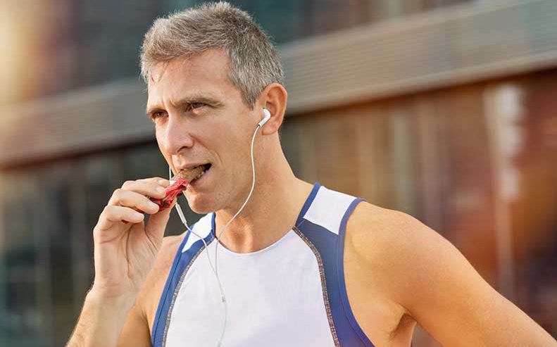 man eating energy bar