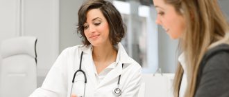 Female doctor talking with patient about May-Thurner syndrome