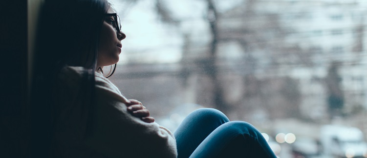 Teenage girl looking out the window