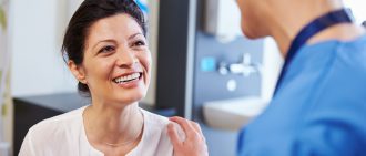 Female patient being reassured by doctor