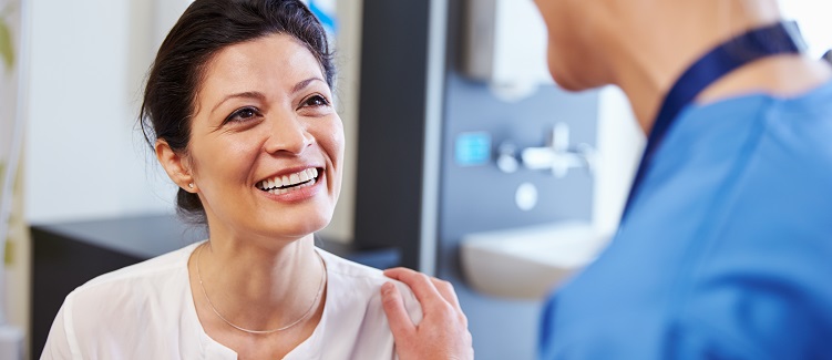 Female patient being reassured by doctor