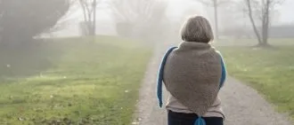 Back view of an older lady on road