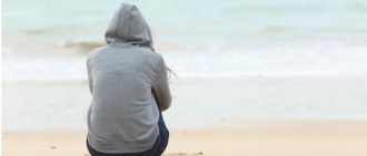 Person contemplating life at the beach