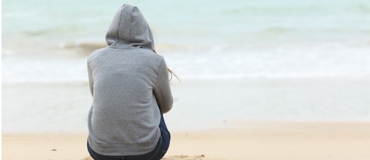 Person contemplating life at the beach