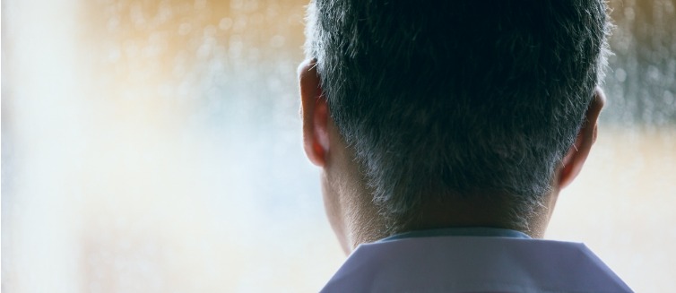 Man thinking gazing out window
