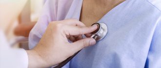 Doctor checking patient's heart