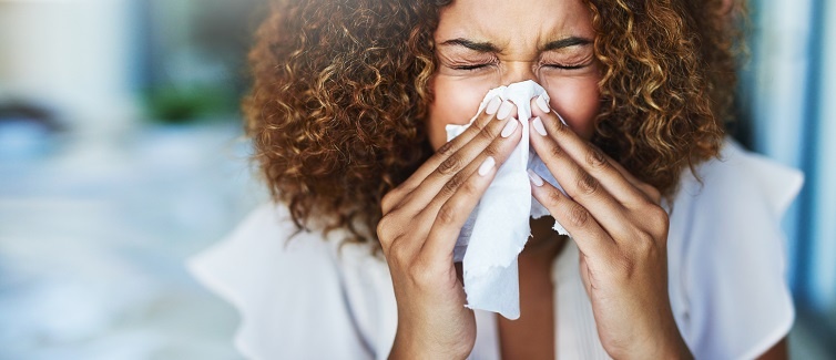 Woman blowing nose