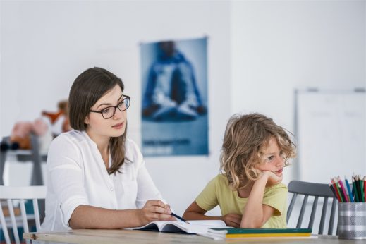 Student with ADHD working with their teacher