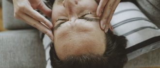 A person rubs their temples during a headache.
