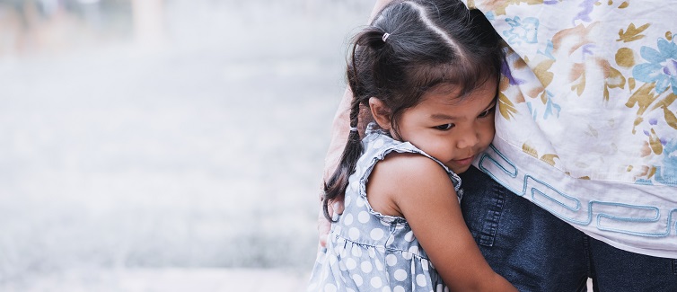 little girl hugging her mother